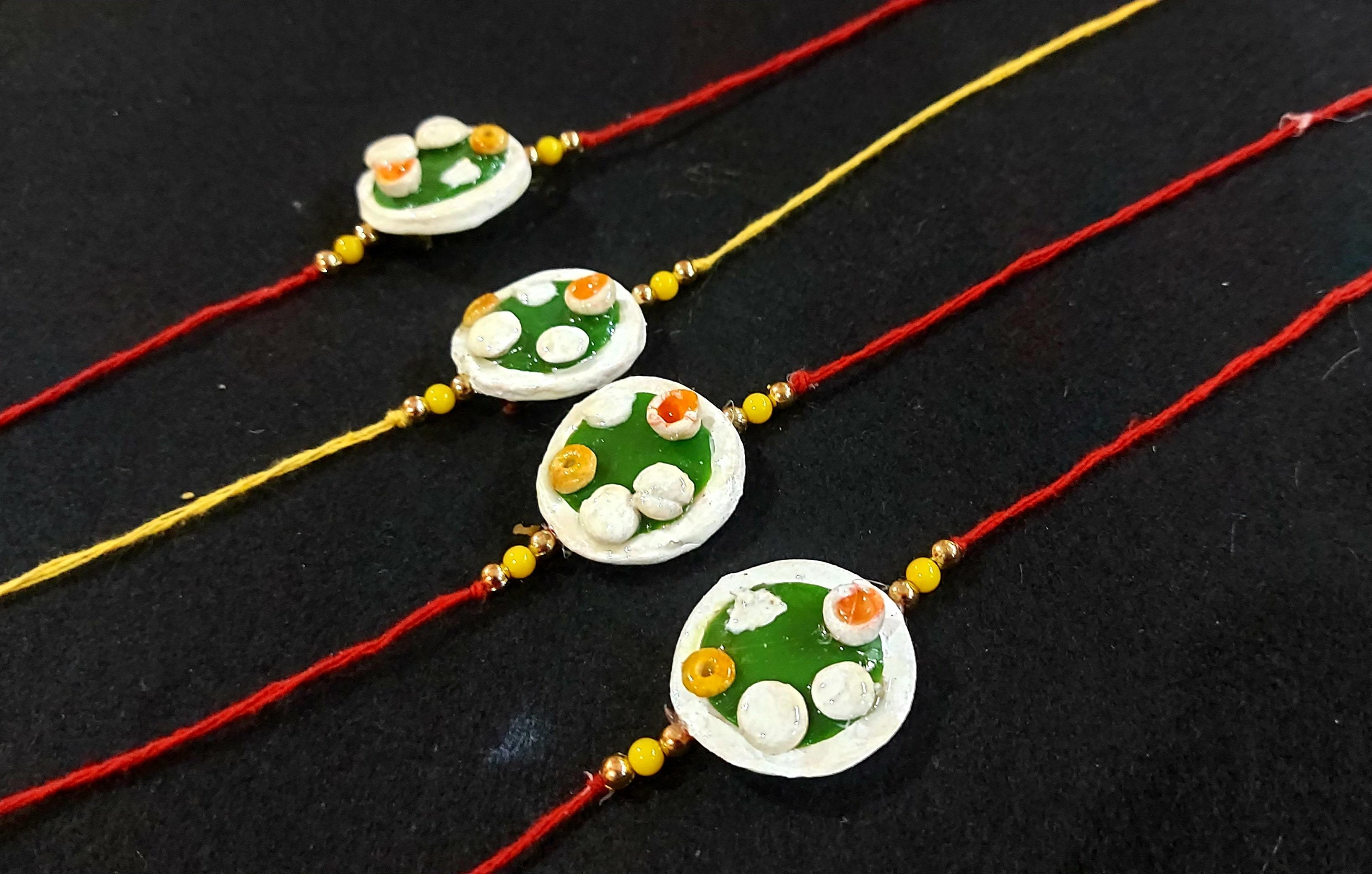 Designer Rakhies - Gold, 2x3 Inches, Red | Handmade Resin Rakhi, Elegant Design, Pearl Accents, Gift Box Packaging, Durable
