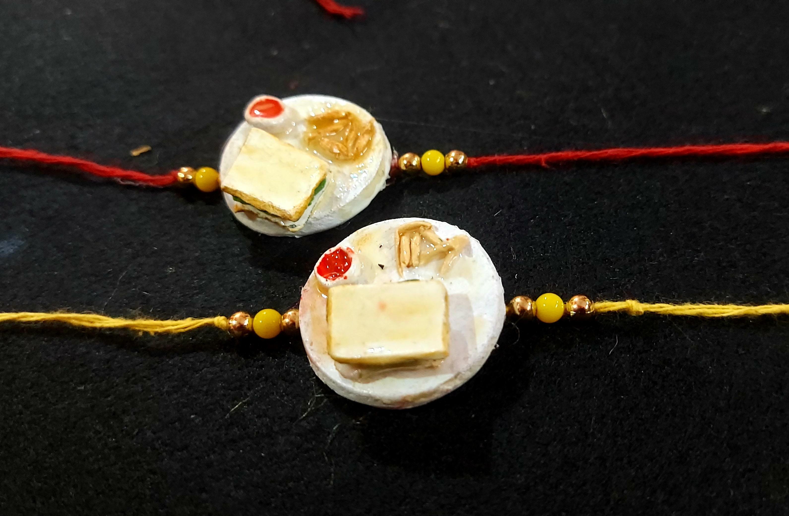 Designer Rakhies - Gold, 2x3 Inches, Red | Handmade Resin Rakhi, Elegant Design, Pearl Accents, Gift Box Packaging, Durable