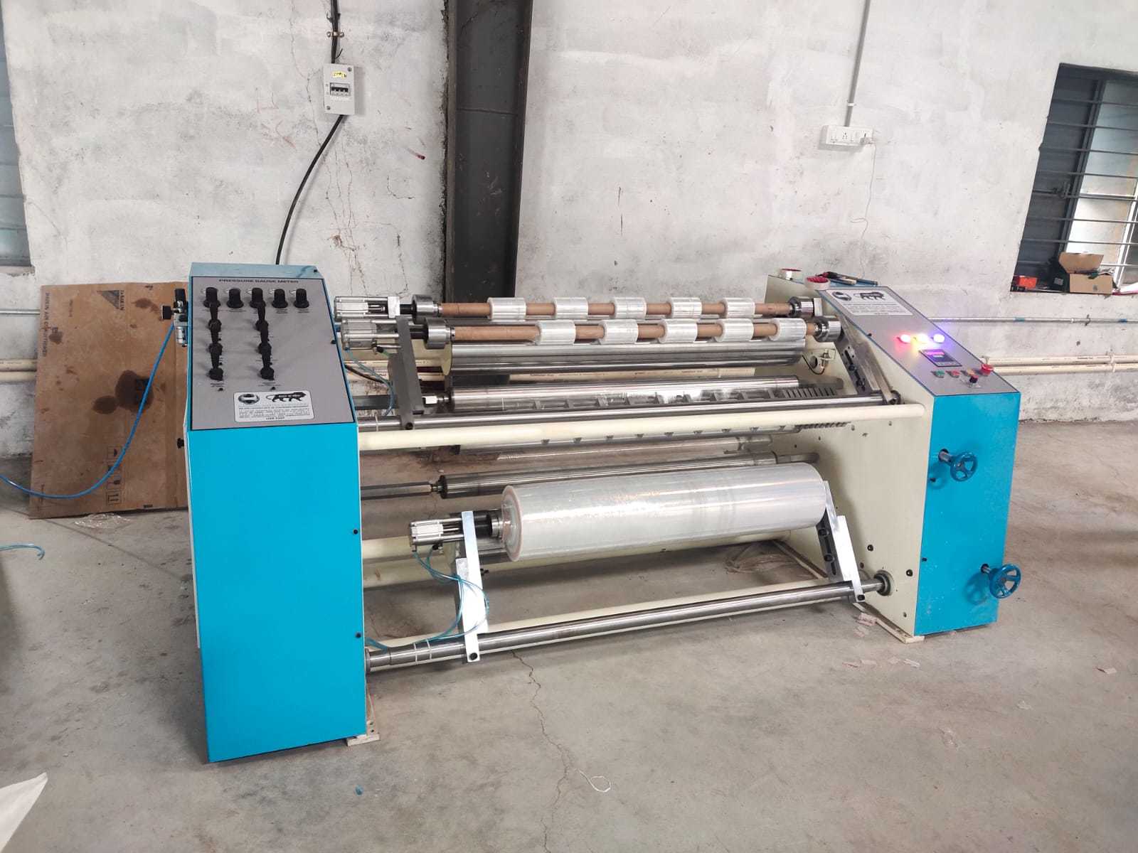 Automatic Stretch Film Slitter Rewinder - 4ftx8ftx4ft Dimensions, White & Light Blue Color | Pneumatic Arrangement, 10 Microns To 60 Microns Thickness, 3-year Warranty