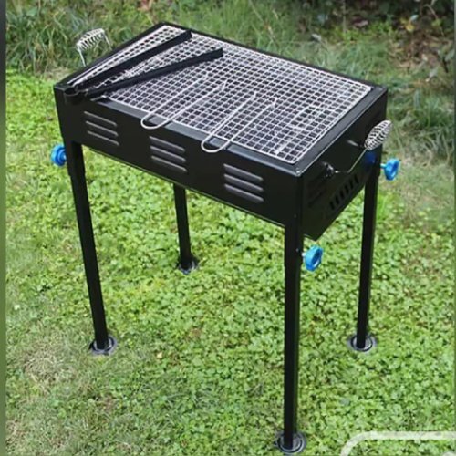 Black Barbecue With Skewers And Wooden Handle