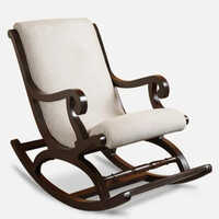 कुशन के साथ लकड़ी की रॉकिंग चेयर पर नक्काशी करना