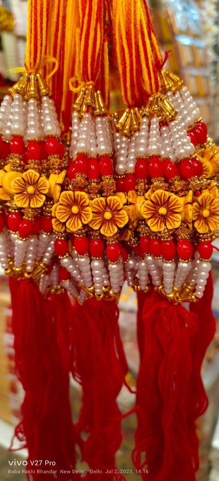Fancy Rakhi New Modal - Beads And Thread, 20 Cm Length, Red Color , Auspicious Occasion, Elegant Design, Sibling Bonding With Traditional Motif